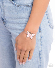 Load image into Gallery viewer, Featuring a glossy finish, an asymmetrical pink-painted butterfly patterned with accents of darker pink whimsically dances along a dainty silver snake chain. Three white gems decrease in size along the butterfly's body for a radiant finish around the wrist. Features an adjustable sliding knot closure. Sold as one individual bracelet.