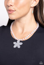 Load image into Gallery viewer, Infused along an invisible string around the neckline, a collection of milky white beads alternates with coral, orange, tiffany, and Kohlrabi seed beads. Featuring an iridescent rhinestone center and a pink rhinestone accent, a white acrylic flower dangles from the center of the display for a nostalgic finish. Features an adjustable clasp closure. Due to its prismatic palette, color may vary. Sold as one individual necklace. Includes one pair of matching earrings.