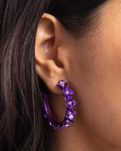 Load image into Gallery viewer, Dipped in a purple hue, a hollowed-out hoop curls around the ear. Featuring silver beaded centers, metallic purple flowers bloom along the curl of the hollow of the hoop for a fashionable display. Earring attaches to a standard post fitting. Hoop measures approximately 1 1/4" in diameter. Sold as one pair of hoop earrings.