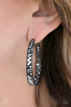 Load image into Gallery viewer, The front facing surface of a chunky black hoop is dipped in brilliantly sparkling hematite rhinestones while light-catching texture wraps around the back. The interior of the hoop features the opposite pattern, creating the illusion of a full hoop of blinding Blockbuster shimmer. Earring attaches to a standard post fitting. Hoop measures 1 3/4" in diameter. Sold as one pair of hoop earrings.