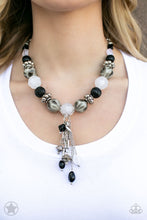 Load image into Gallery viewer, Smooth beads with a marbleized black and white swirl alternate with milky white and silver accents. A tassel of chains in various lengths is decorated with black, silver, and frosty pieces. Features an adjustable clasp closure. Sold as one individual necklace. Includes one pair of matching earrings.