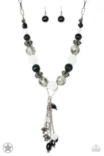 Load image into Gallery viewer, Smooth beads with a marbleized black and white swirl alternate with milky white and silver accents. A tassel of chains in various lengths is decorated with black, silver, and frosty pieces. Features an adjustable clasp closure. Sold as one individual necklace. Includes one pair of matching earrings.