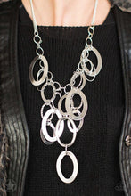 Load image into Gallery viewer, Large silver links and shimmering textured silver rings cascade below a silver chain freely, allowing for movement that makes a bold statement. Features an adjustable clasp closure. Sold as one individual blockbuster necklace. Includes one pair of matching earrings.