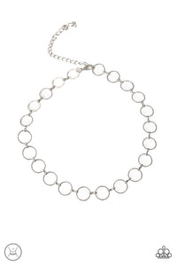 Dainty silver rings link around the neck for an edgy look. Features an adjustable clasp closure.  Sold as one individual choker necklace. Includes one pair of matching earrings.