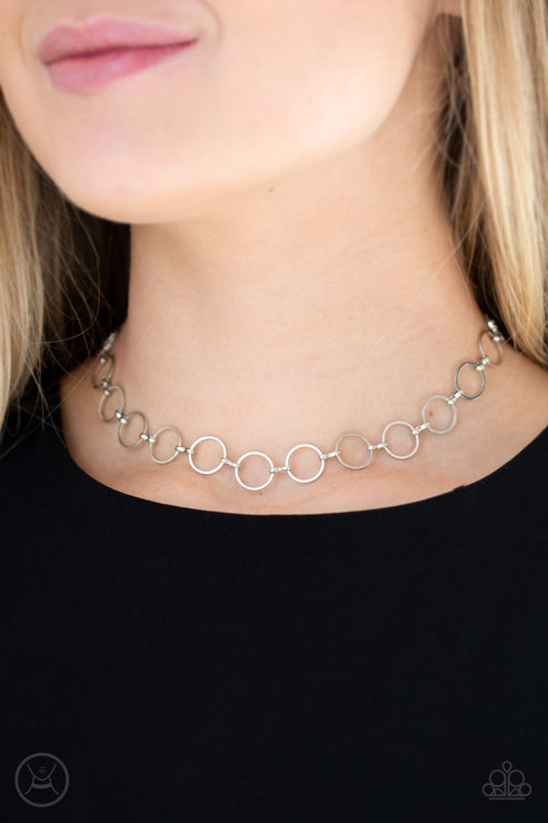 Dainty silver rings link around the neck for an edgy look. Features an adjustable clasp closure.  Sold as one individual choker necklace. Includes one pair of matching earrings.