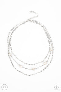 Infused with two oval-linked silver chains, imperfect white pearls adorn a dainty silver chain around the neck for a summery layered look. Features an adjustable clasp closure.  Sold as one individual choker necklace. Includes one pair of matching earrings.