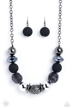 Load image into Gallery viewer, Sophisticated beads in shades of gunmetal and black with reflective faceted edges and varying glazed finishes are offset by two shiny silver beads. An oblong bead studded with gunmetal rhinestones adds a dramatic accent. Features an adjustable clasp closure.  Sold as one individual necklace. Includes one pair of matching earrings.
