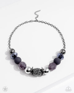 Sophisticated beads in shades of gunmetal and black with reflective faceted edges and varying glazed finishes are offset by two shiny silver beads. An oblong bead studded with gunmetal rhinestones adds a dramatic accent. Features an adjustable clasp closure.  Sold as one individual necklace. Includes one pair of matching earrings.