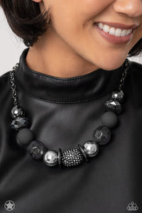 Sophisticated beads in shades of gunmetal and black with reflective faceted edges and varying glazed finishes are offset by two shiny silver beads. An oblong bead studded with gunmetal rhinestones adds a dramatic accent. Features an adjustable clasp closure.  Sold as one individual necklace. Includes one pair of matching earrings.