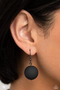 Single black bead hanging from a gunmetal fish hook earring.