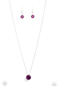 A single fuchsia rhinestone sparkles brilliantly at the bottom of a dainty silver chain, creating a stunning solitaire design. Features an adjustable clasp closure.  Sold as one individual necklace. Includes one pair of matching earrings.