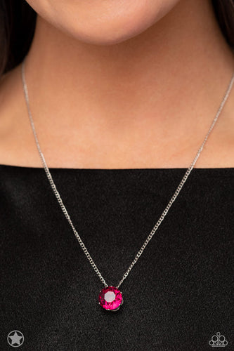A single fuchsia rhinestone sparkles brilliantly at the bottom of a dainty silver chain, creating a stunning solitaire design. Features an adjustable clasp closure.  Sold as one individual necklace. Includes one pair of matching earrings.