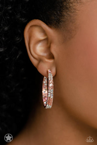 The front facing surface of a chunky shiny copper hoop is dipped in brilliantly sparkling iridescent, peach, and white rhinestones while light-catching texture wraps around the back. The interior of the hoop features the opposite pattern, creating the illusion of a full hoop of blinding rhinestones. Earring attaches to a standard post fitting. Hoop measures 1 3/4
