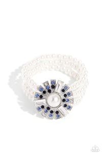 Strung along elastic stretchy bands, three bands of pearls wrap around the wrist. Featured atop the pearly collection, sleek metal bars flare out from a mesmerizing pearl center, creating a stacked blue and white rhinestone-encrusted fringe of fanning frames. A trio of emerald-cut white gem bars are sprinkled across the dazzling display for a sassy finish.