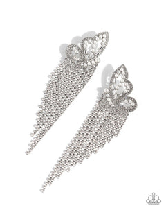 Glassy white rhinestones, dainty white pearls, and white emerald-cut gems are encrusted along the front of an airy silver butterfly frame, creating a whimsical centerpiece. Staggered rows of white rhinestones pressed in delicate silver square fittings cascade from the sparkly centerpiece, seemingly lifting the butterfly off to its glitzy flight. Earring attaches to a standard post fitting. Sold as one pair of post earrings.