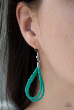Load image into Gallery viewer, Turquoise seed bead circle hanging from a silver fish hook earring.
