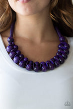 Load image into Gallery viewer, Brushed in a distressed finish, vivacious purple wooden beads and discs join below the collar for a summery look. Features a button loop closure.  Sold as one individual necklace. Includes one pair of matching earrings.
