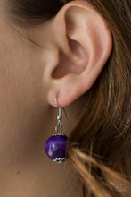 Load image into Gallery viewer, Purple wooden bead dangling from a silver fish hook earring.
