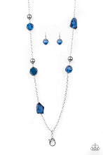 Load image into Gallery viewer, A collection of faceted blue gems, opaque blue beads, and polished silver beads trickle down a shimmery silver chain for a glamorous look. A lobster clasp hangs from the bottom of the design to allow a name badge or other item to be attached. Features an adjustable clasp closure.  Sold as one individual lanyard. Includes one pair of matching earrings.

