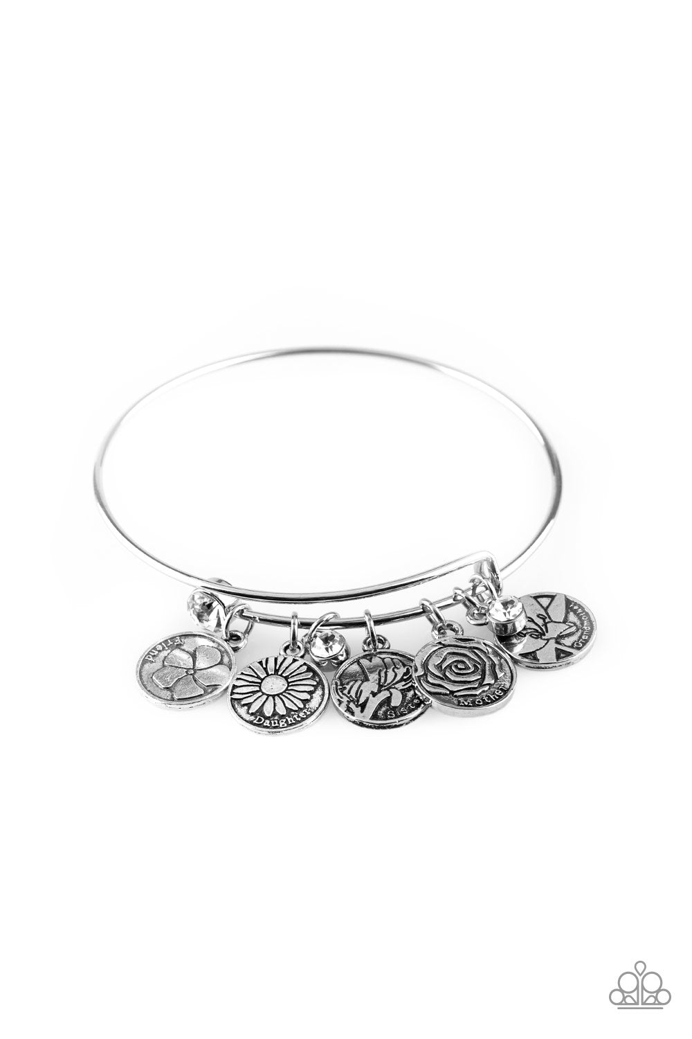 A skinny silver wire is adorned by a collection of small silver charms. Each charm features a floral design and one of the many titles that women hold throughout their lives. Words include, “Mother”, “Grandmother”, “Sister”, Daughter”, and “Friend.” A small white rhinestone is nestled among the silver charms, while a larger one is placed as an end cap on the spiraling wire, both adding sparkling accents to the piece. The coil can be expanded to accommodate a larger wrist.  Sold as one individual bracelet.