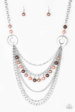 Load image into Gallery viewer, Dramatic silver hoops give way to layers of mismatched silver chains. Pearly brown, pink, and tan beads trickle from the second chain, creating a flirty fringe across the chest. Features an adjustable clasp closure.  Sold as one individual necklace. Includes one pair of matching earrings.
