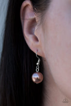 Load image into Gallery viewer, Tan pearl hanging from a silver fish hook earring.
