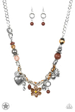Load image into Gallery viewer, Brown and ivory cording is braided through a chunky silver chain. A unique variety of charms decorate the Blockbuster piece, including a delicate flower and a heart inscribed with the phrase &quot;With All My Heart&quot; on one side and a short bible verse on the other that reads, &quot;Love the Lord thy God with all your heart. Luke 10:27.&quot; Features an adjustable clasp closure. Sold as one individual necklace. Includes one pair of matching earrings.
