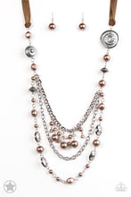Load image into Gallery viewer, A silky brown ribbon replaces a traditional chain to give an elegant look. Pearly brown beads and funky silver pieces intermix with varying lengths of silver chains to give a fresh take on a Victorian-inspired Blockbuster piece.   Sold as one individual necklace. Includes one pair of matching earrings.
