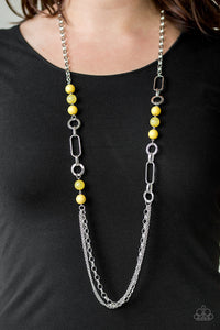 A collection of glassy and polished yellow beads give way to layers of mismatched silver chain for a whimsical look. Features an adjustable clasp closure.  Sold as one individual necklace. Includes one pair of matching earrings.