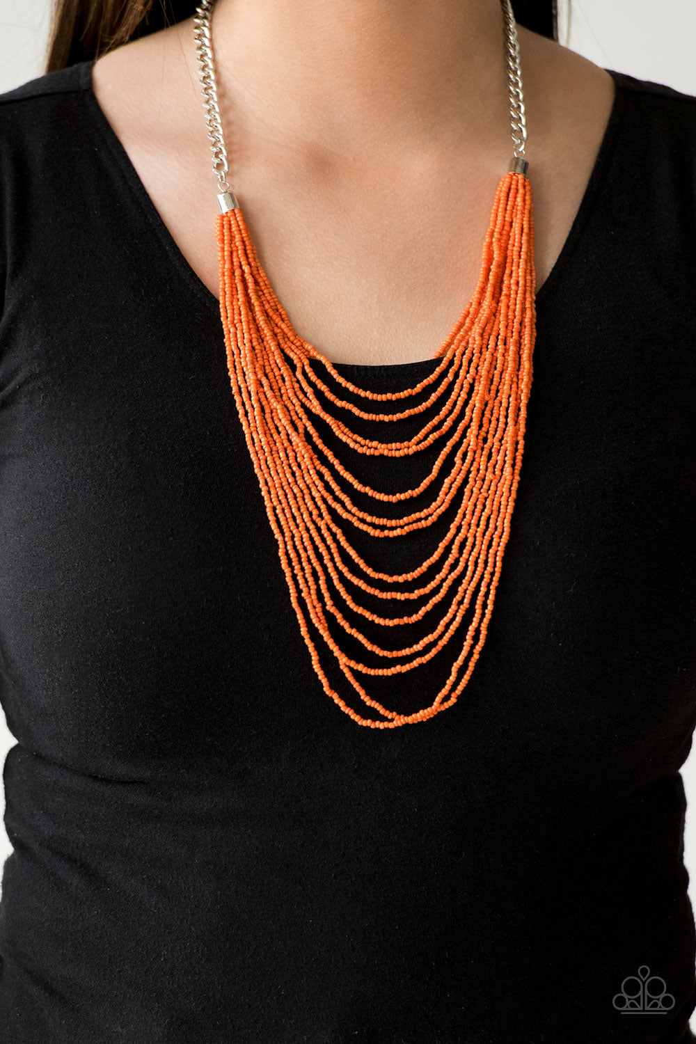 Row after row of vivacious orange seed beads cascade down the chest, creating summery layers. Features an adjustable clasp closure.  Sold as one individual necklace. Includes one pair of matching earrings.