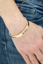 Load image into Gallery viewer, A sleek gold cuff wraps around the wrist in a casual fashion. Dotted with a dainty white rhinestone, the shimmery cuff is engraved in the word “Mother” for a loving finish.  Sold as one individual bracelet.
