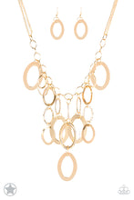 Load image into Gallery viewer, Large gold links and shimmering textured gold rings cascade below a gold chain freely, allowing for movement that makes a bold statement. Features an adjustable clasp closure. Sold as one individual necklace with matching earrings.
