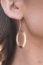 Load image into Gallery viewer, Gold oval ring hanging from a gold fish hook earring.
