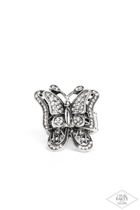 Dazzling white rhinestones are sprinkled across the wings of a silver butterfly, creating a whimsical frame atop the finger. Features a stretchy band for a flexible fit.  Sold as one individual ring.