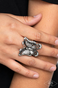 Dazzling white rhinestones are sprinkled across the wings of a silver butterfly, creating a whimsical frame atop the finger. Features a stretchy band for a flexible fit.  Sold as one individual ring.