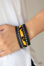 Load image into Gallery viewer, A thick band of black leather has been spliced into layered bands that have been studded and printed in a fuzzy cheetah print for a wild look. Features an adjustable snap closure.  Sold as one individual bracelet.
