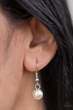 Load image into Gallery viewer, White pearl hanging from a silver fish hook earring.
