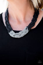 Load image into Gallery viewer, Strands of black seed beads create an indigenous braid below the collar. The black seed beads gradually morph into metallic silver beads at the center for a chic contrasting look. Features an adjustable clasp closure.  Sold as one individual necklace. Includes one pair of matching earrings.
