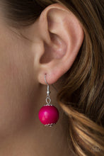 Load image into Gallery viewer, Pink wooden bead dangling from a silver fish hook earring.
