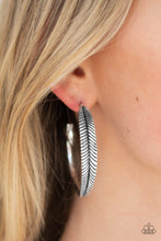 Load image into Gallery viewer, Featuring lifelike textures, a glistening silver feather hoop curls around the ear for a seasonal look. Earring attaches to a standard post fitting. Hoop measures 2&quot; in diameter. Sold as one pair of hoop earrings.
