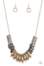 Load image into Gallery viewer, Gradually increasing in size, a collision of faceted tin finished silver, gunmetal, and brass rings slide along a classic brass chain below the collar for a bold industrial look. Features an adjustable clasp closure.  Sold as one individual necklace. Includes one pair of matching earrings.
