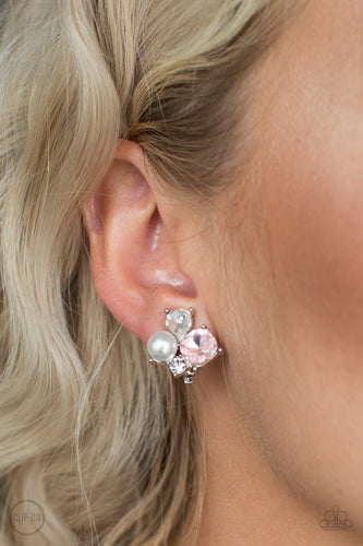 Featuring a classic pearl, mismatched pink and white rhinestones join into a radiant frame. Earring attaches to a standard clip-on fitting.  Sold as one pair of clip-on earrings.