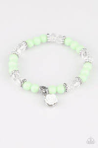 Colored beads with clear beads, silver accent beads, with a white rose that dangles on a stretchy bracelet.