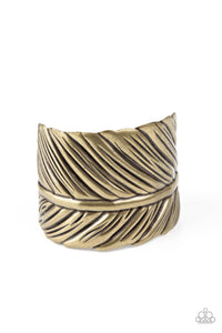 Embossed in life-like texture, an antiqued brass feather delicately curls around the wrist, creating a whimsical cuff.  Sold as one individual bracelet.
