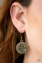 Load image into Gallery viewer, Embossed in a whimsical rosebud pattern, a shimmery brass frame swings from a brass fish hook earring. 
