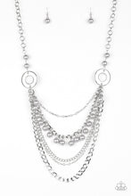 Load image into Gallery viewer, Dramatic silver hoops give way to layers of mismatched silver chains. Pearly silver beads trickle from the second chain, creating a flirty fringe across the chest. Features an adjustable clasp closure. Sold as one individual necklace. Includes one pair of matching earrings.
