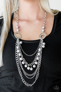 Dramatic silver hoops give way to layers of mismatched silver chains. Pearly silver beads trickle from the second chain, creating a flirty fringe across the chest. Features an adjustable clasp closure. Sold as one individual necklace. Includes one pair of matching earrings.