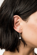 Load image into Gallery viewer, Small white bead hanging from a silver fish hook earring.
