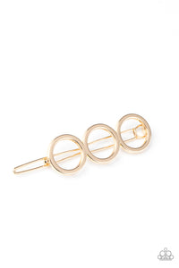 A trio of gold rings delicately connect into an airy minimalist inspired frame. Features a clamp barrette closure.  Sold as one individual hair clip.