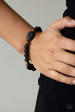 Load image into Gallery viewer, A collection of black lava rocks and earthy Tiger&#39;s Eye stone beads are threaded along a stretchy band around the wrist for a seasonal look. Sold as one individual bracelet.
